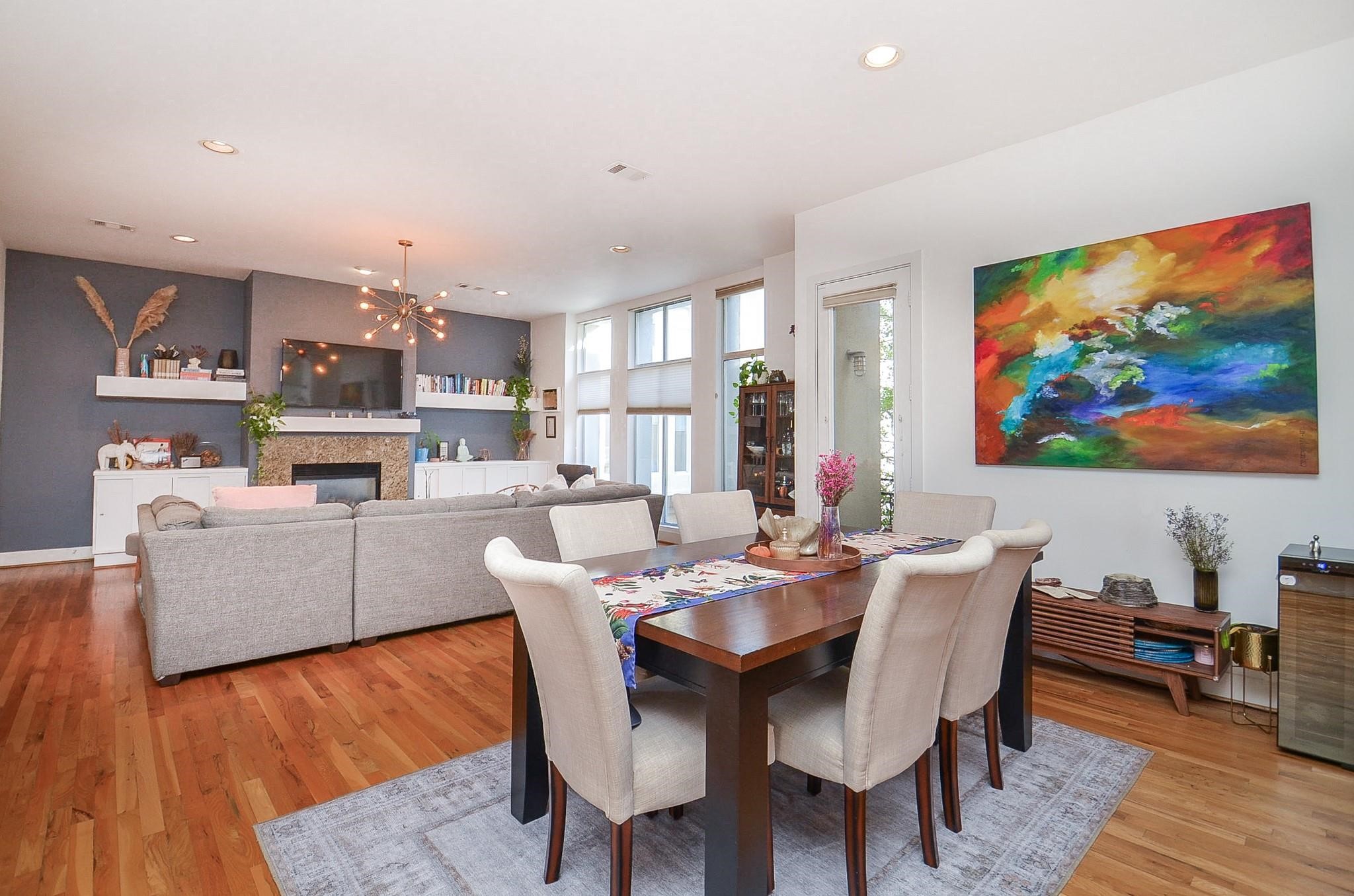 1116 Columbus Street Houston, TX 77019 - Photo 11 of 32 a dining room with furniture a wooden floor and a kitchen view