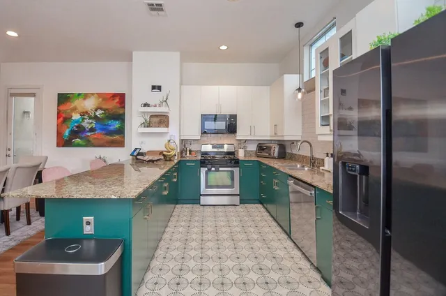 a kitchen with sink refrigerator and microwave