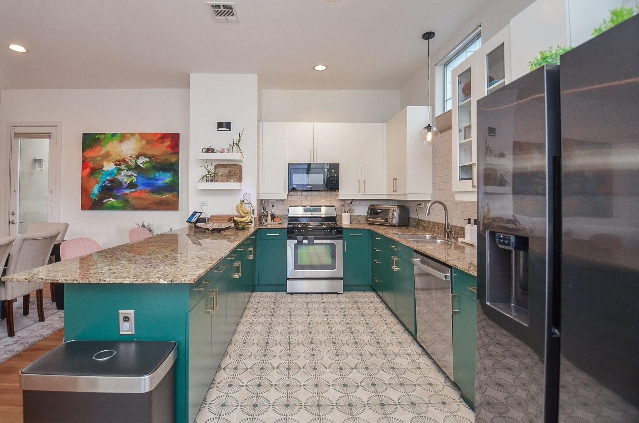 1116 Columbus Street Houston, TX 77019 - Photo 15 of 32 a kitchen with sink refrigerator and microwave