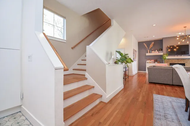 a view of entryway and kitchen with wooden floor