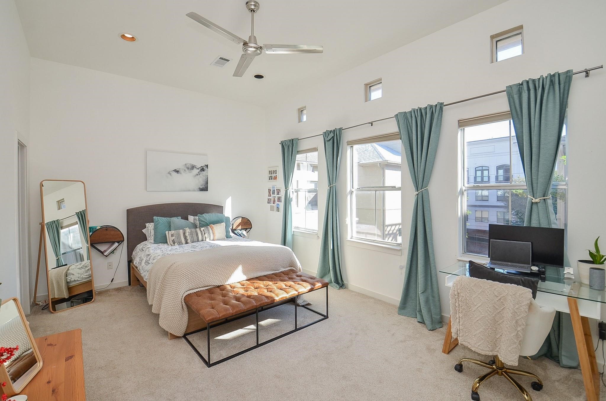 1116 Columbus Street Houston, TX 77019 - Photo 19 of 32 a bedroom with a bed window and a flat screen tv