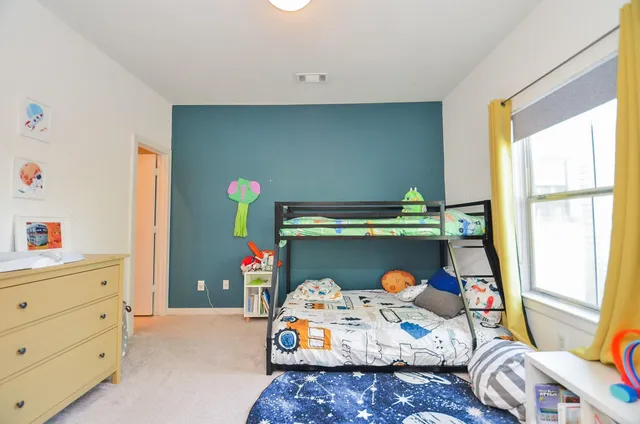 a bed room with furniture and a window