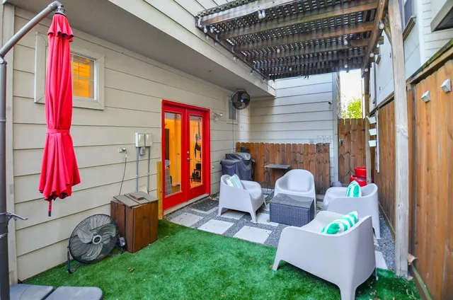 a backyard of a house with barbeque oven table and chairs