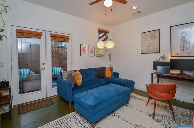 a living room with furniture a rug and a window