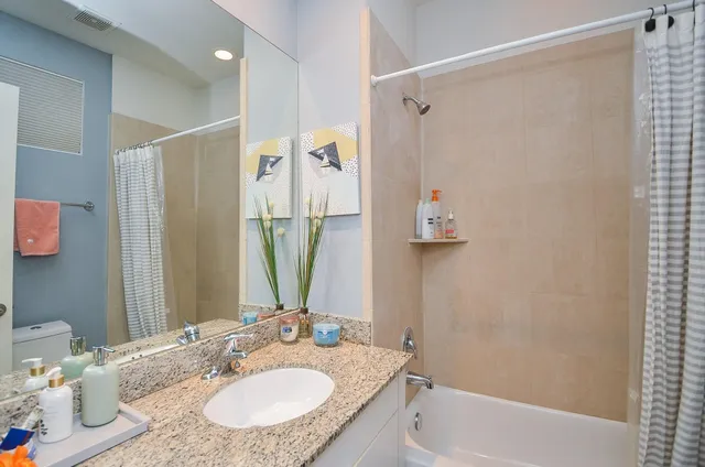 a bathroom with a granite countertop sink and a mirror