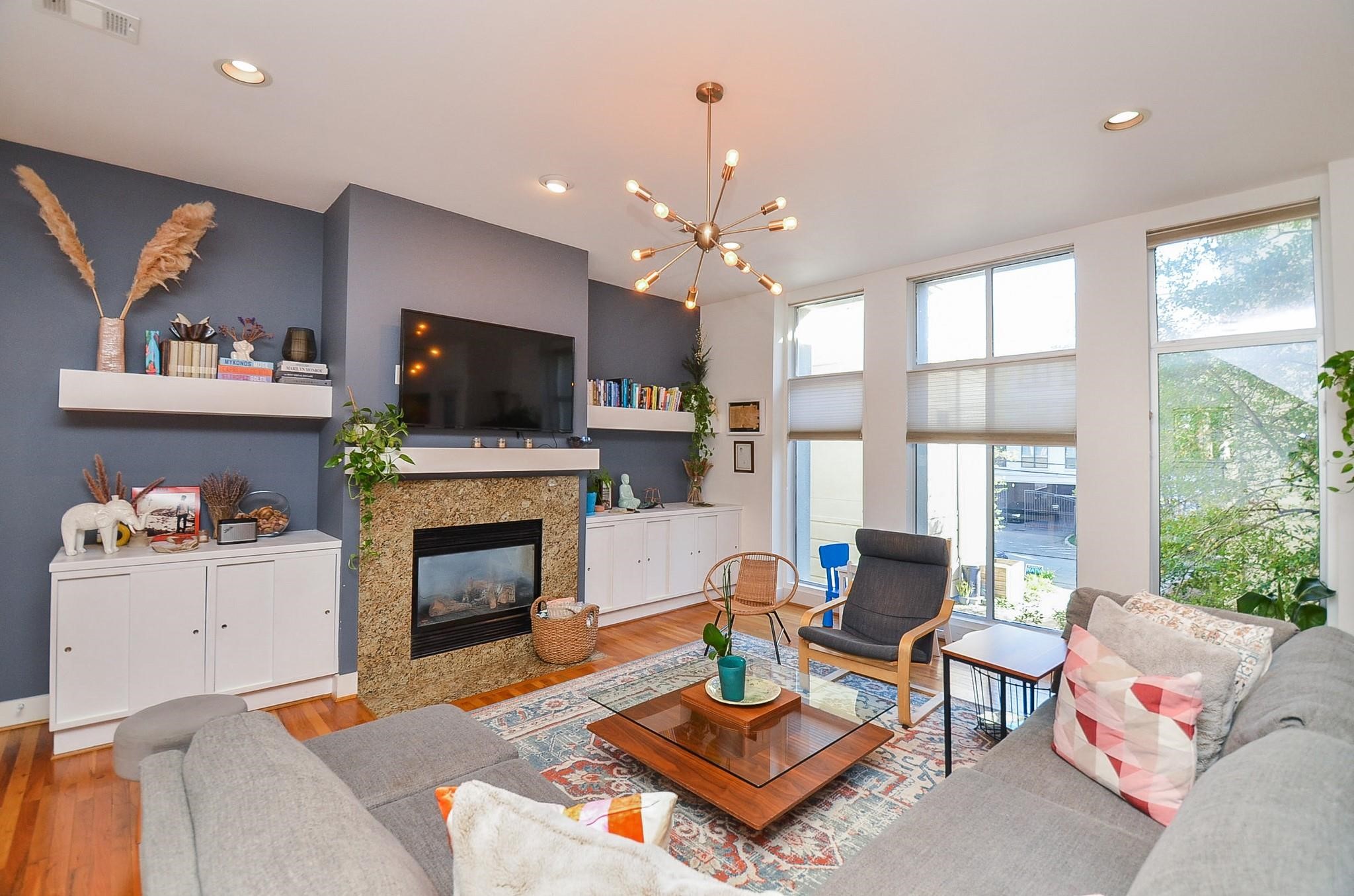 1116 Columbus Street Houston, TX 77019 - Photo 8 of 32 a living room with furniture a flat screen tv and a fireplace