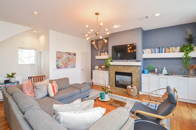 a living room with furniture a fireplace and a flat screen tv