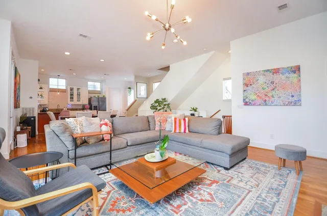 a living room with furniture and a chandelier