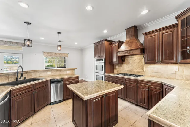 a kitchen with a sink stove and cabinets