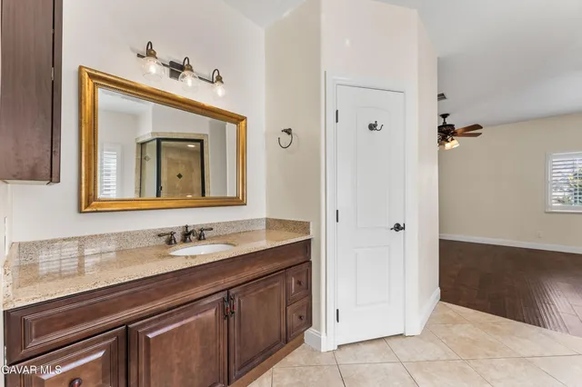 a view of a livingroom with hardwood floor and a ceiling fan