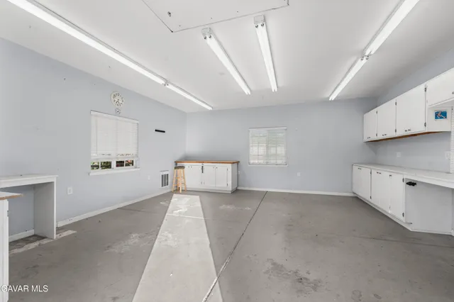 a view of a house with wooden fence