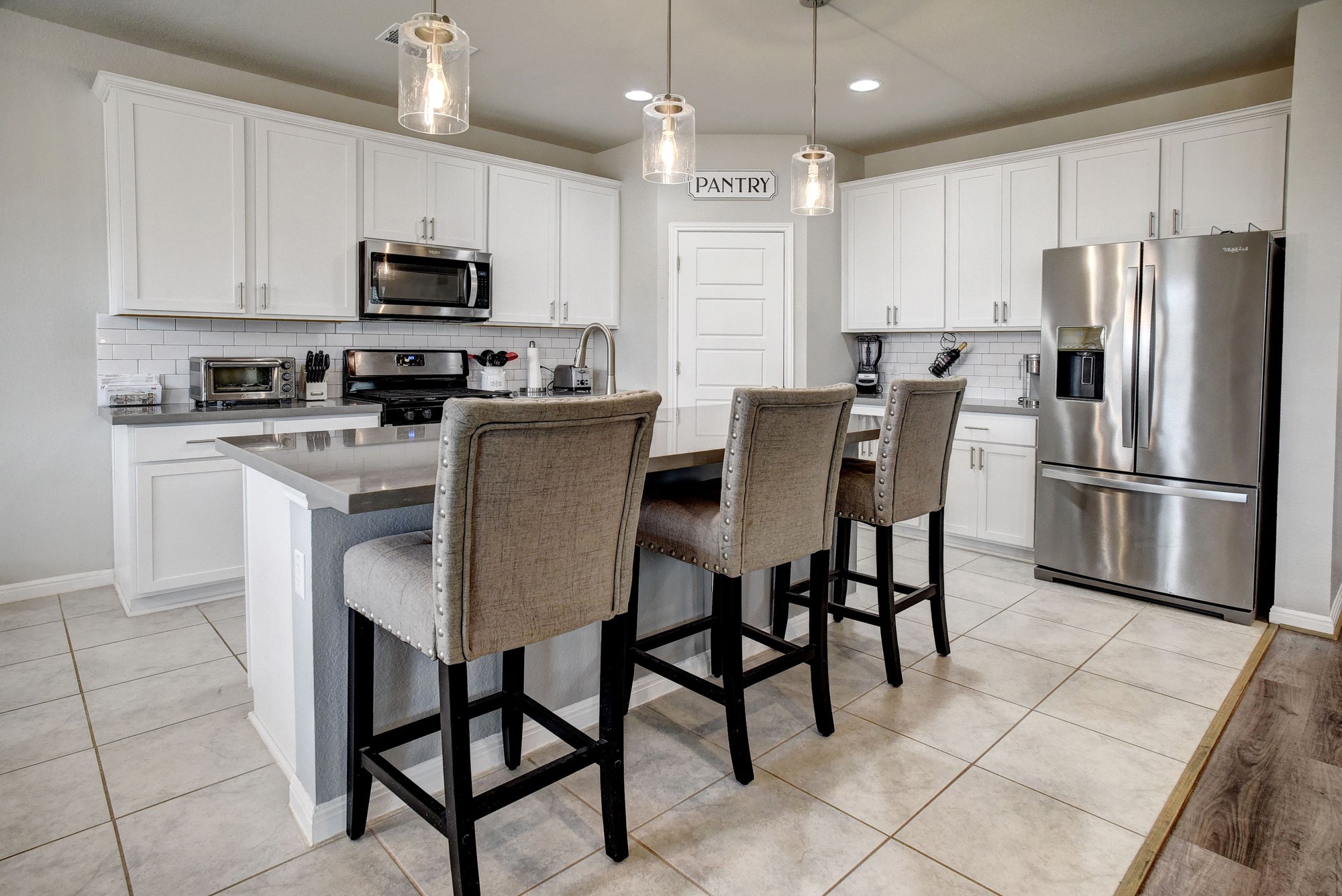210 Cold Spg Loop, Unit 1 Bastrop, TX 78602 - Photo 11 of 40 a kitchen with stainless steel appliances granite countertop a dining table chairs microwave and sink