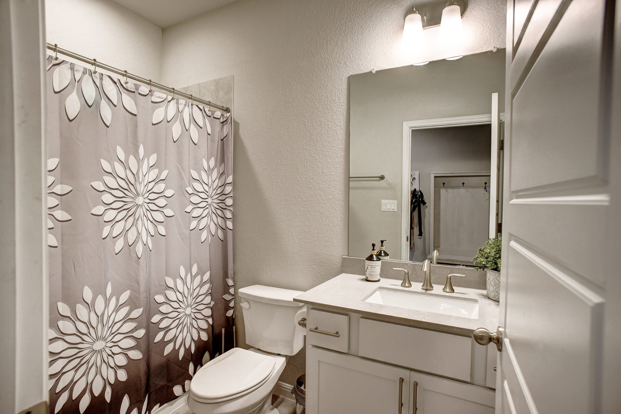 210 Cold Spg Loop, Unit 1 Bastrop, TX 78602 - Photo 19 of 40 a bathroom with a granite countertop sink toilet and shower