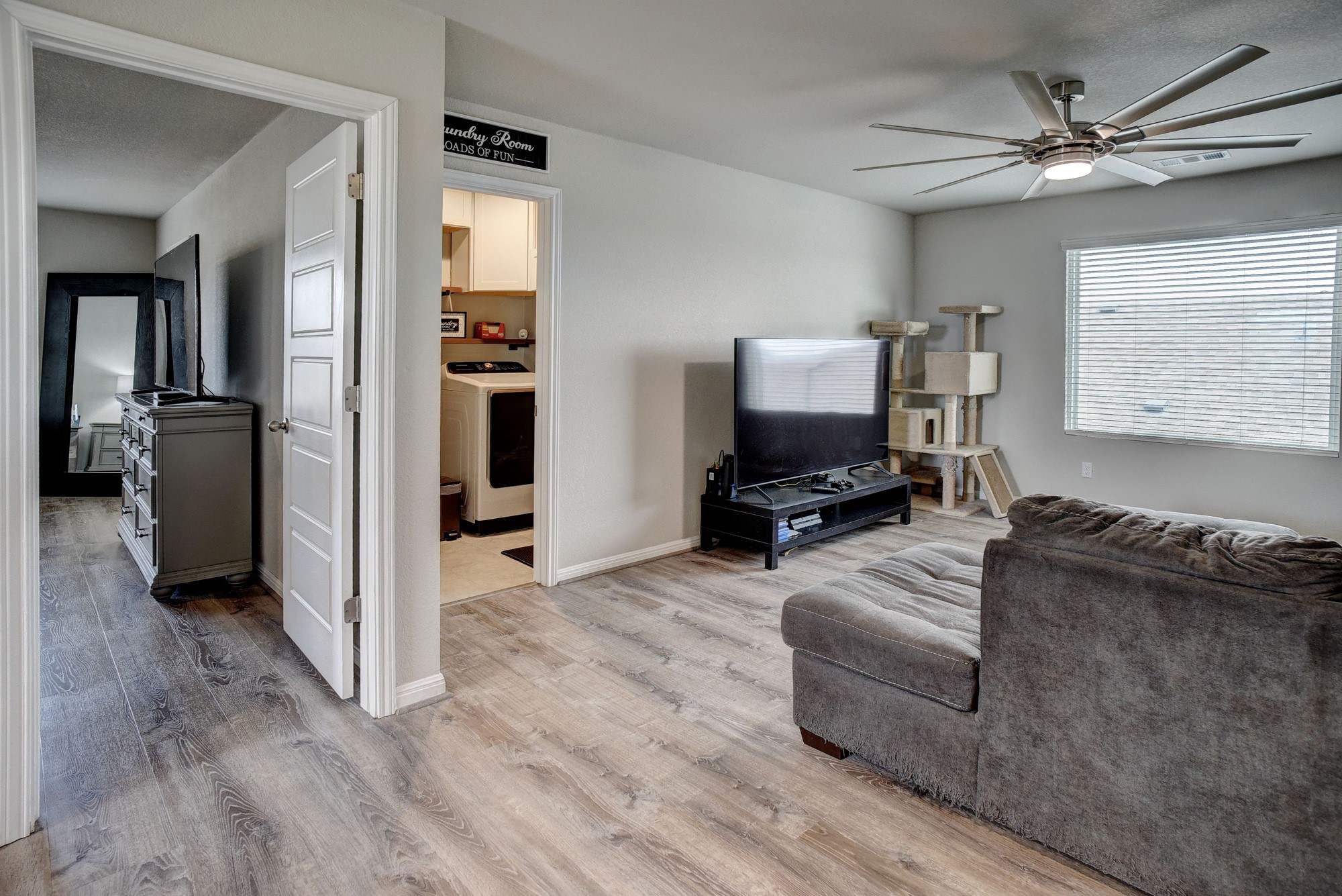 210 Cold Spg Loop, Unit 1 Bastrop, TX 78602 - Photo 24 of 40 a living room with furniture and a flat screen tv