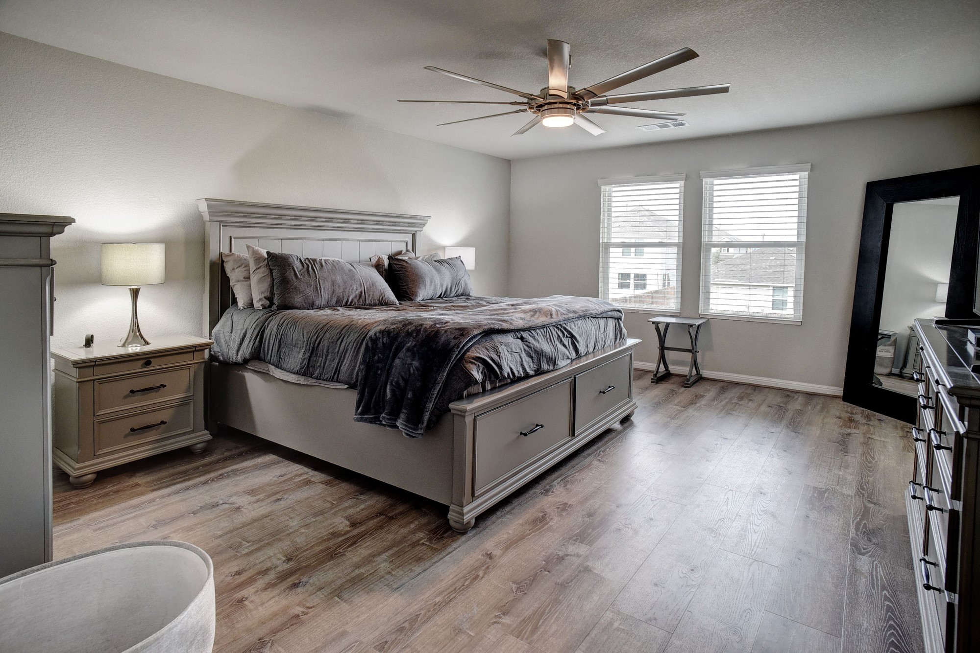 210 Cold Spg Loop, Unit 1 Bastrop, TX 78602 - Photo 25 of 40 a spacious bedroom with a bed and a flat screen tv