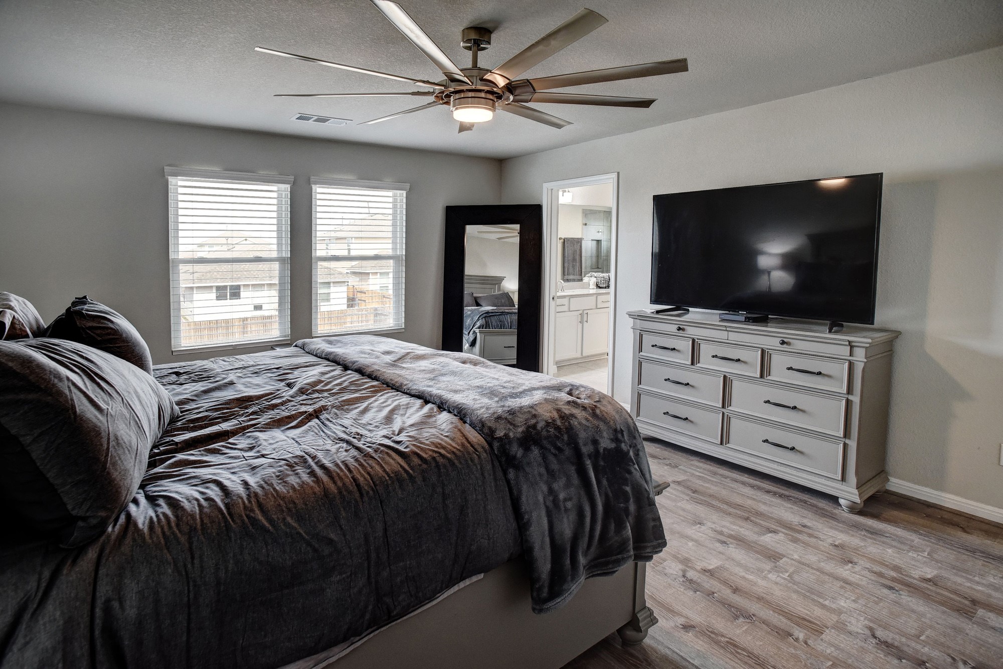 210 Cold Spg Loop, Unit 1 Bastrop, TX 78602 - Photo 27 of 40 a bedroom with a bed and a flat screen tv