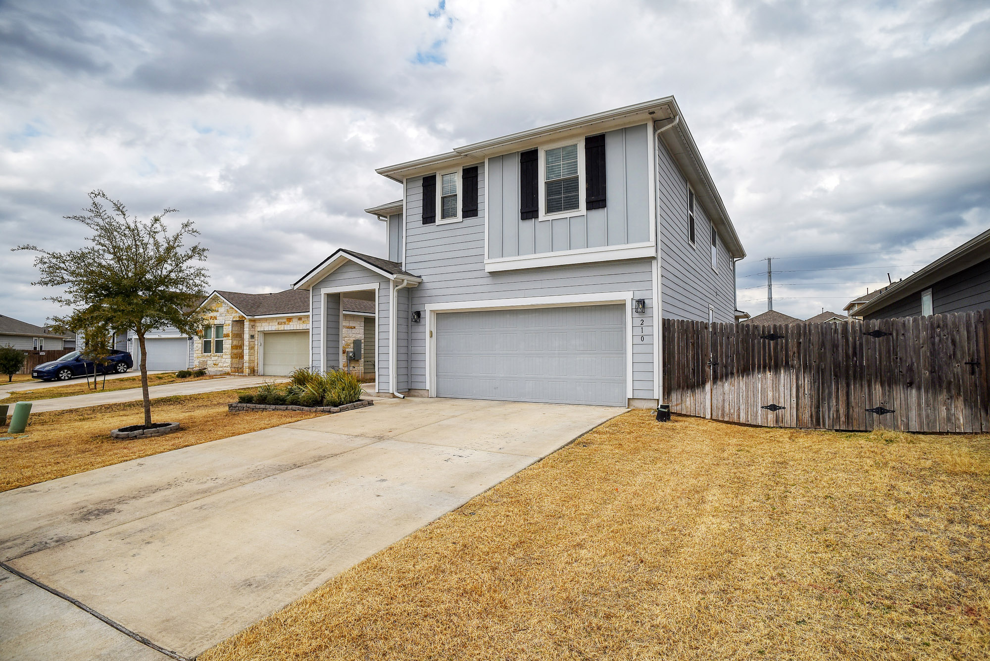 210 Cold Spg Loop, Unit 1 Bastrop, TX 78602 - Photo 5 of 40 a front view of house with yard and trees in the background