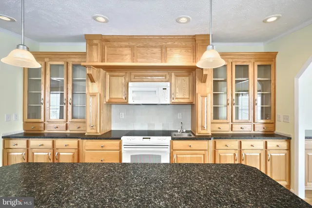 a view of a dining room with furniture a chandelier and wooden floor