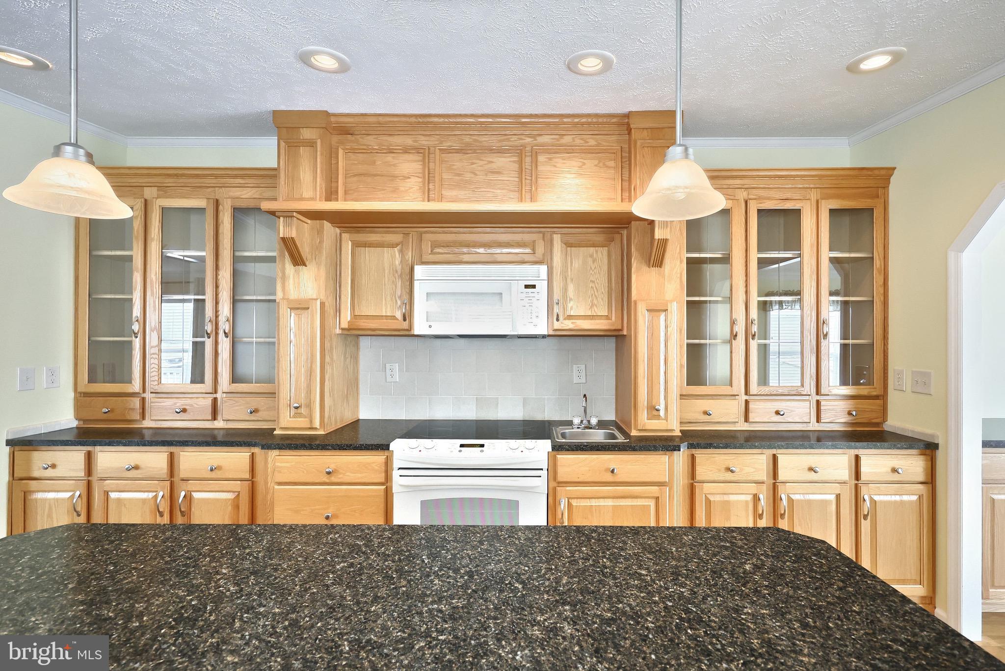 267 Runaway Road Abbottstown, PA 17301 - Photo 14 of 38 a kitchen with a stove a sink and a refrigerator
