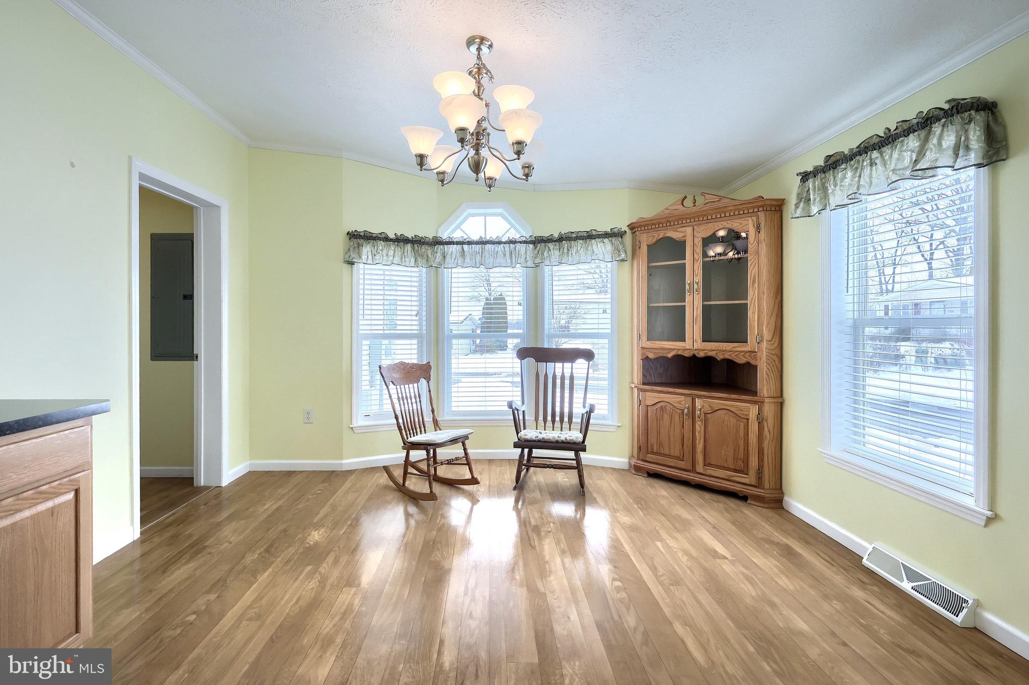 267 Runaway Road Abbottstown, PA 17301 - Photo 15 of 38 a view of a dining room with furniture a chandelier and wooden floor