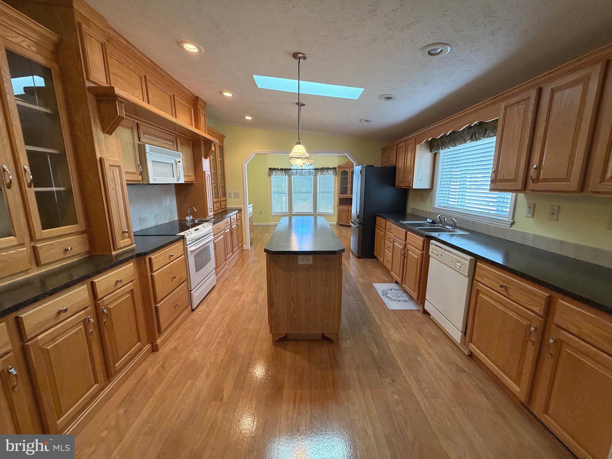 267 Runaway Road Abbottstown, PA 17301 - Photo 2 of 3 a kitchen with stainless steel appliances wooden floors wooden cabinets a sink and a stove