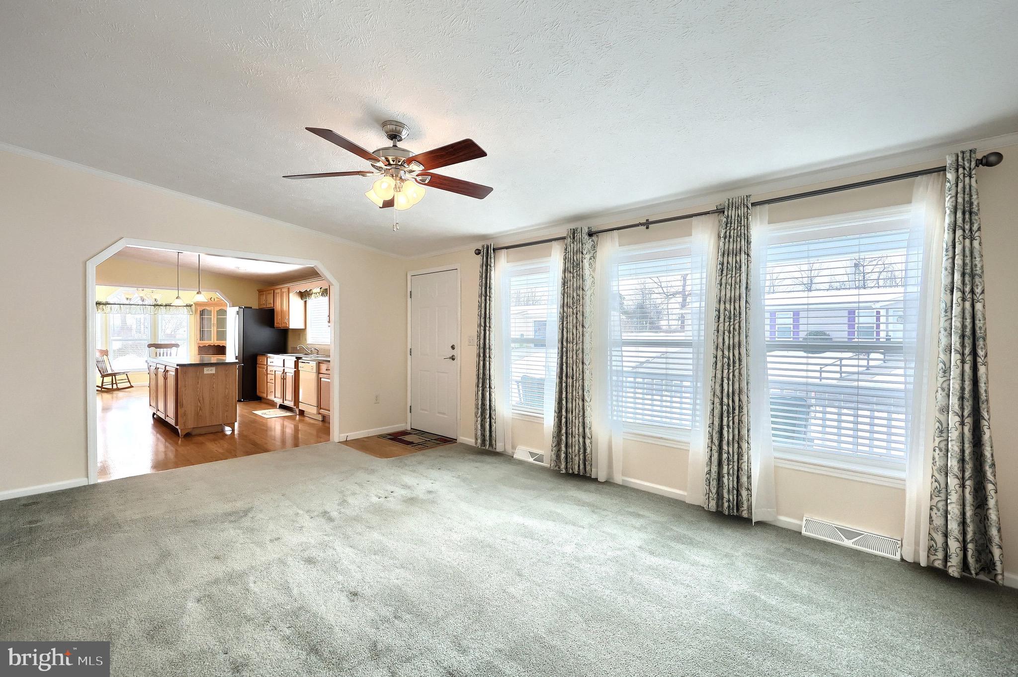 267 Runaway Road Abbottstown, PA 17301 - Photo 10 of 38 a view of a livingroom with a ceiling fan and kitchen view