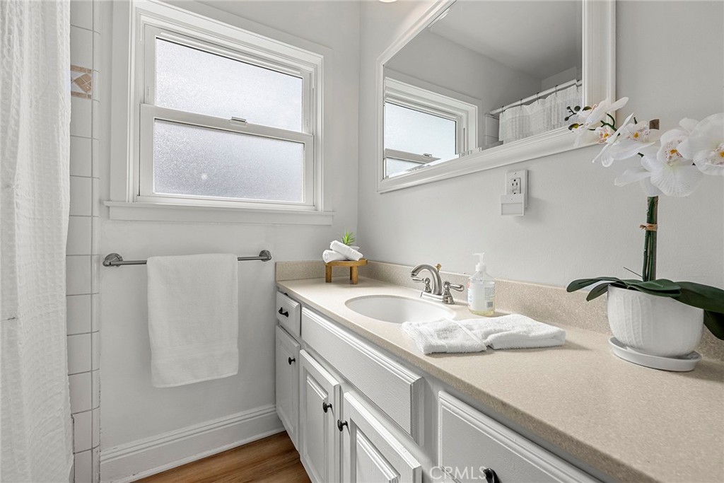 907 Chestnut Avenue Brea, CA 92821 - Photo 17 of 35 a bathroom with a granite countertop sink and a mirror