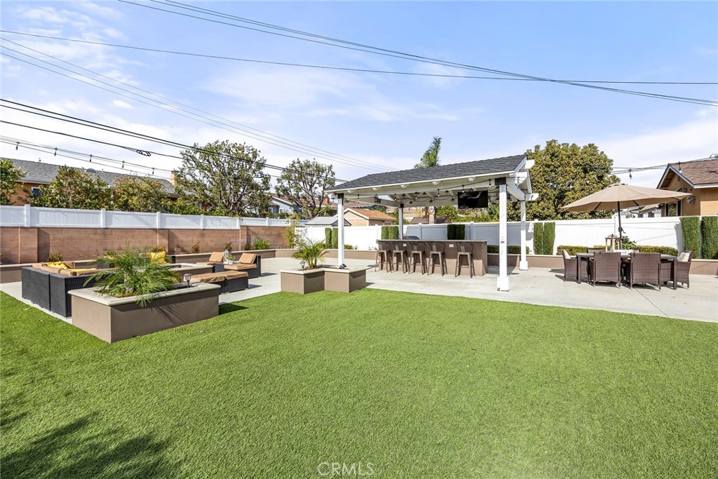 907 Chestnut Avenue Brea, CA 92821 - Photo 21 of 35 a view of a patio with couches and table and chairs and potted plants