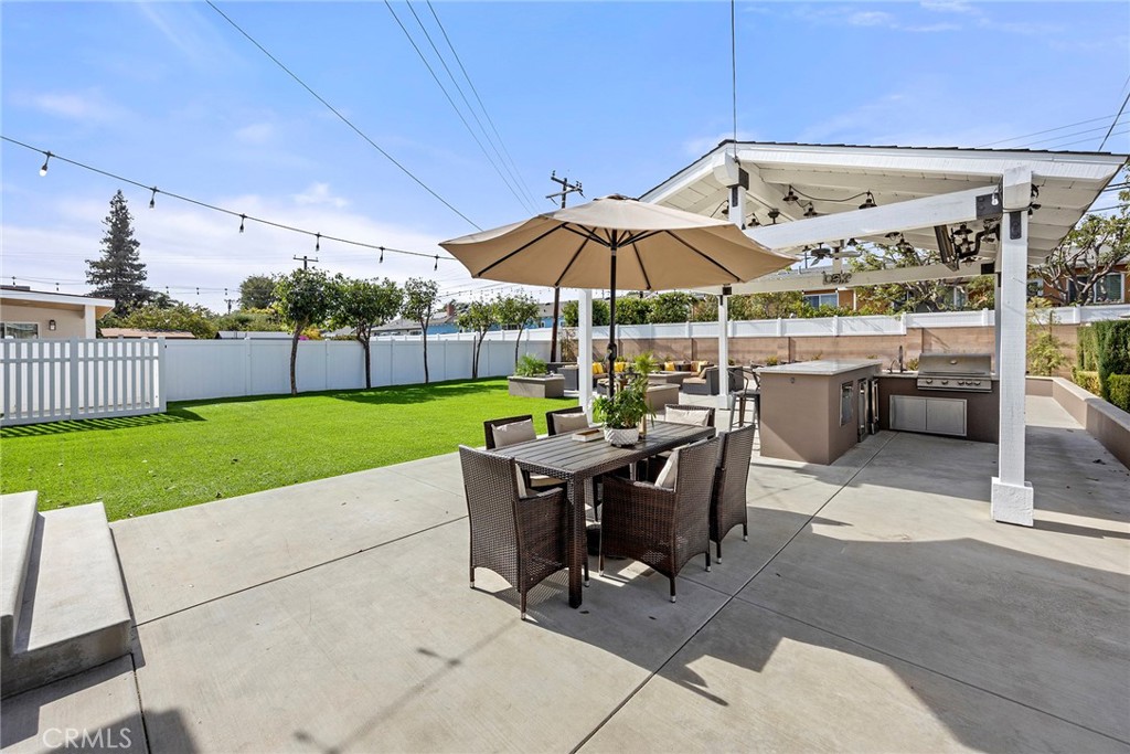 907 Chestnut Avenue Brea, CA 92821 - Photo 23 of 35 a view of a patio with a table and chairs under an umbrella