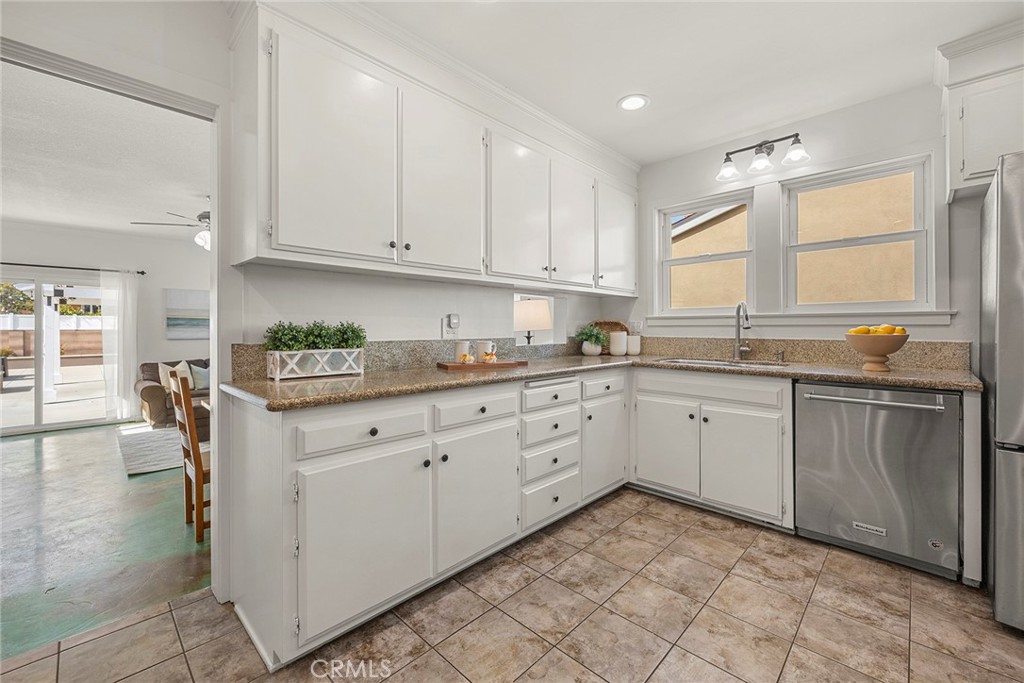 907 Chestnut Avenue Brea, CA 92821 - Photo 6 of 35 a kitchen with granite countertop white cabinets and white appliances