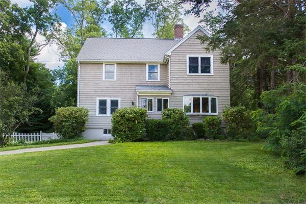 10 Briggs Road Lexington, MA 02421 - Photo 1 of 30 a front view of a house with a yard and trees