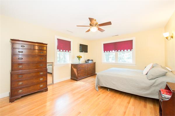 10 Briggs Road Lexington, MA 02421 - Photo 23 of 30 a bedroom with a bed and a ceiling fan