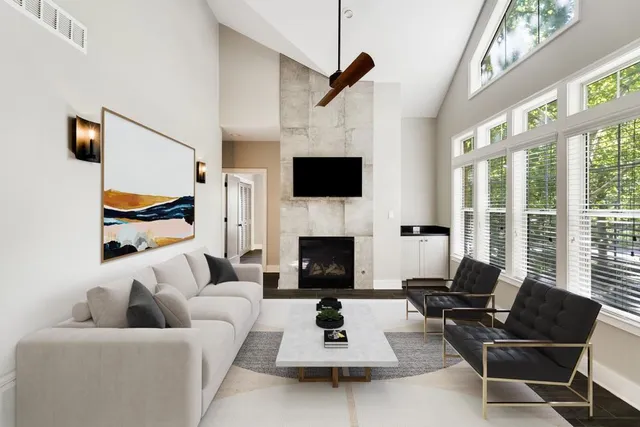 a living room with furniture a fireplace and a flat screen tv