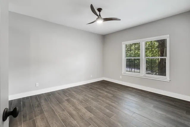 wooden floor in an empty room with a window