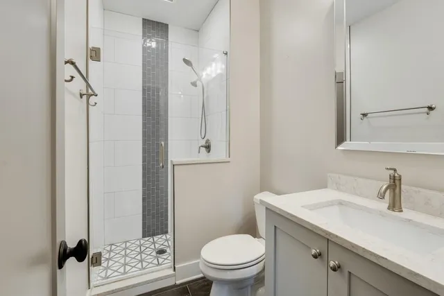 a bathroom with a sink toilet and shower
