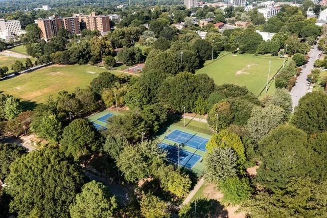 an aerial view of residential house with outdoor space and trees all around