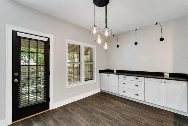 a kitchen with granite countertop white cabinets and a large window