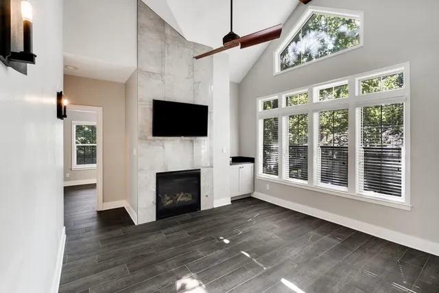 a living room with furniture fireplace and flat screen tv