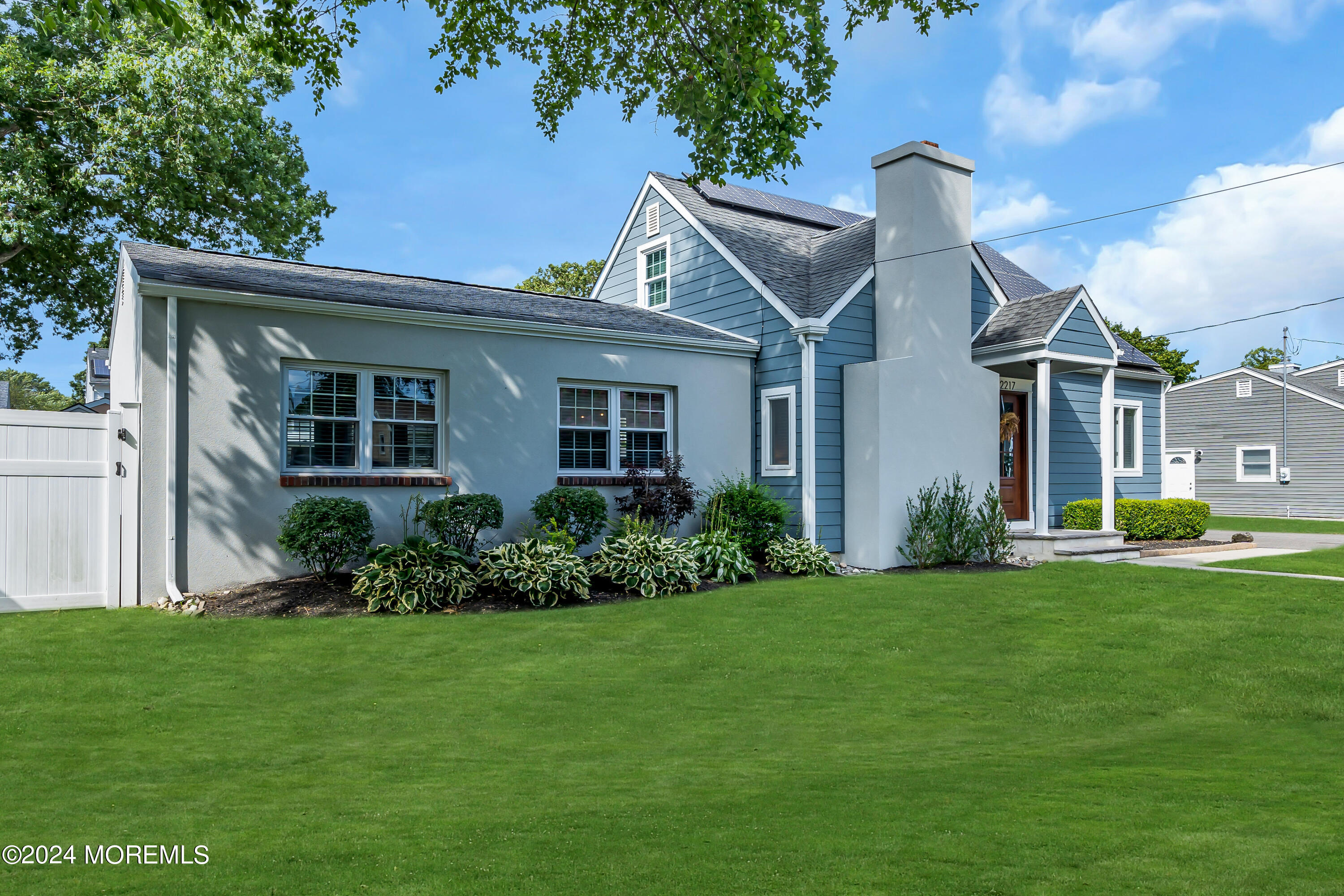 2217 Edgar Road Point Pleasant, NJ 08742 - Photo 4 of 46 a front view of a house with a garden and plants