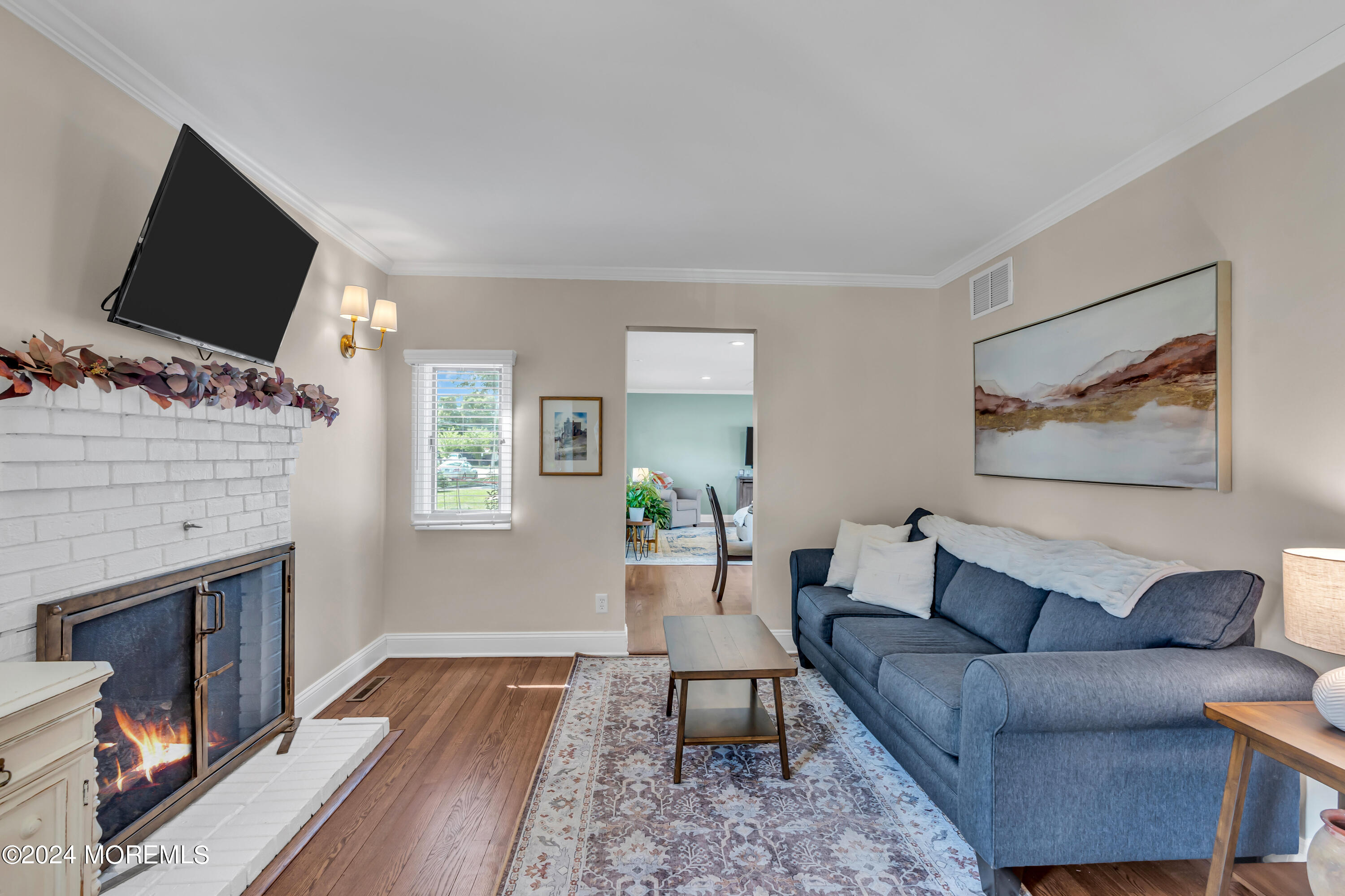 2217 Edgar Road Point Pleasant, NJ 08742 - Photo 7 of 46 a living room with furniture a fireplace and a flat screen tv