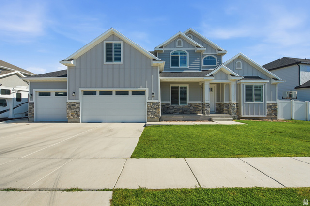 36 West Syracuse Road Vineyard, UT 84059 - Photo 3 of 56 Light grey siding exterior with stone accents