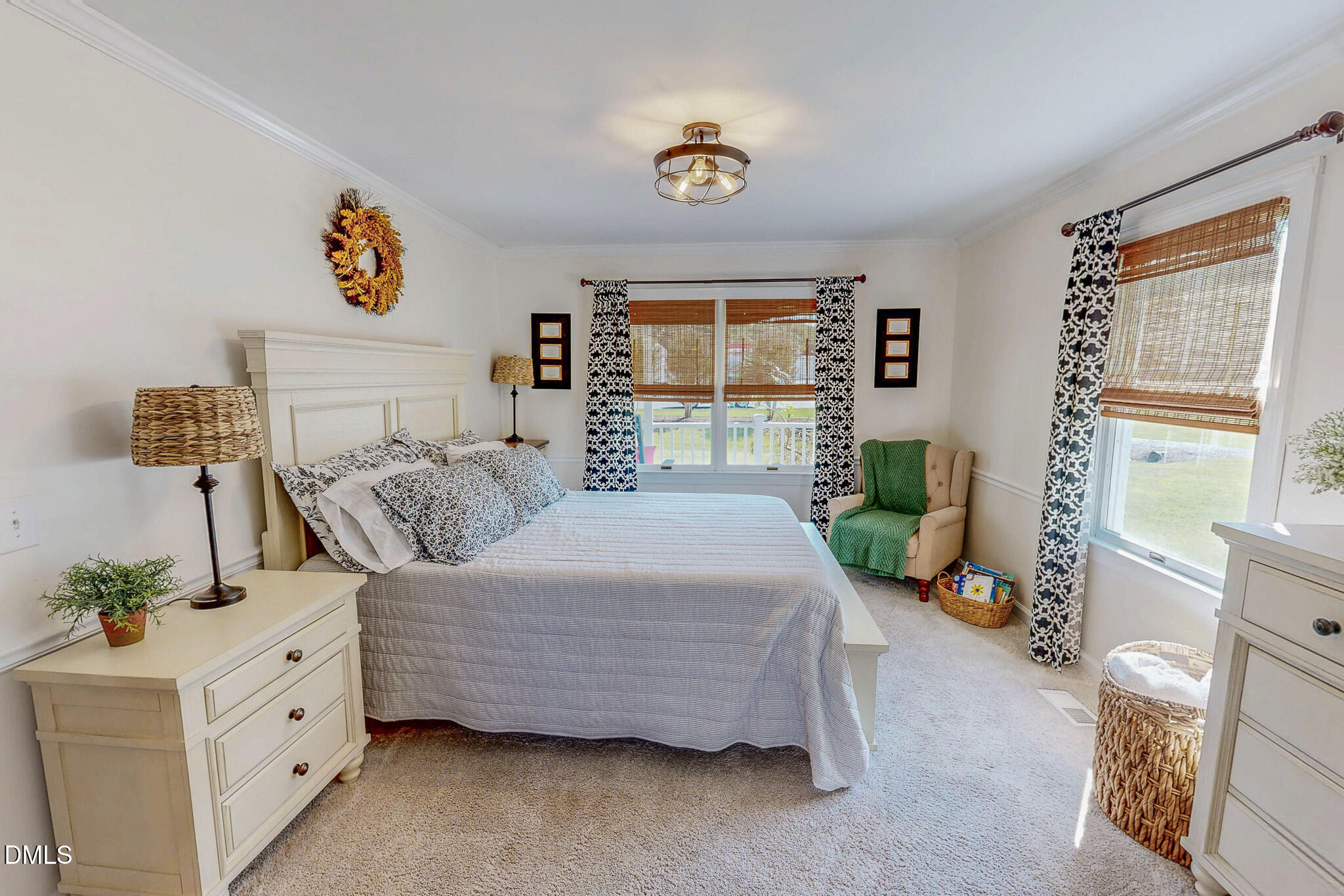 7810 Helena Moriah Road Rougemont, NC 27572 - Photo 15 of 53 a spacious bedroom with a bed a dresser and next to a window