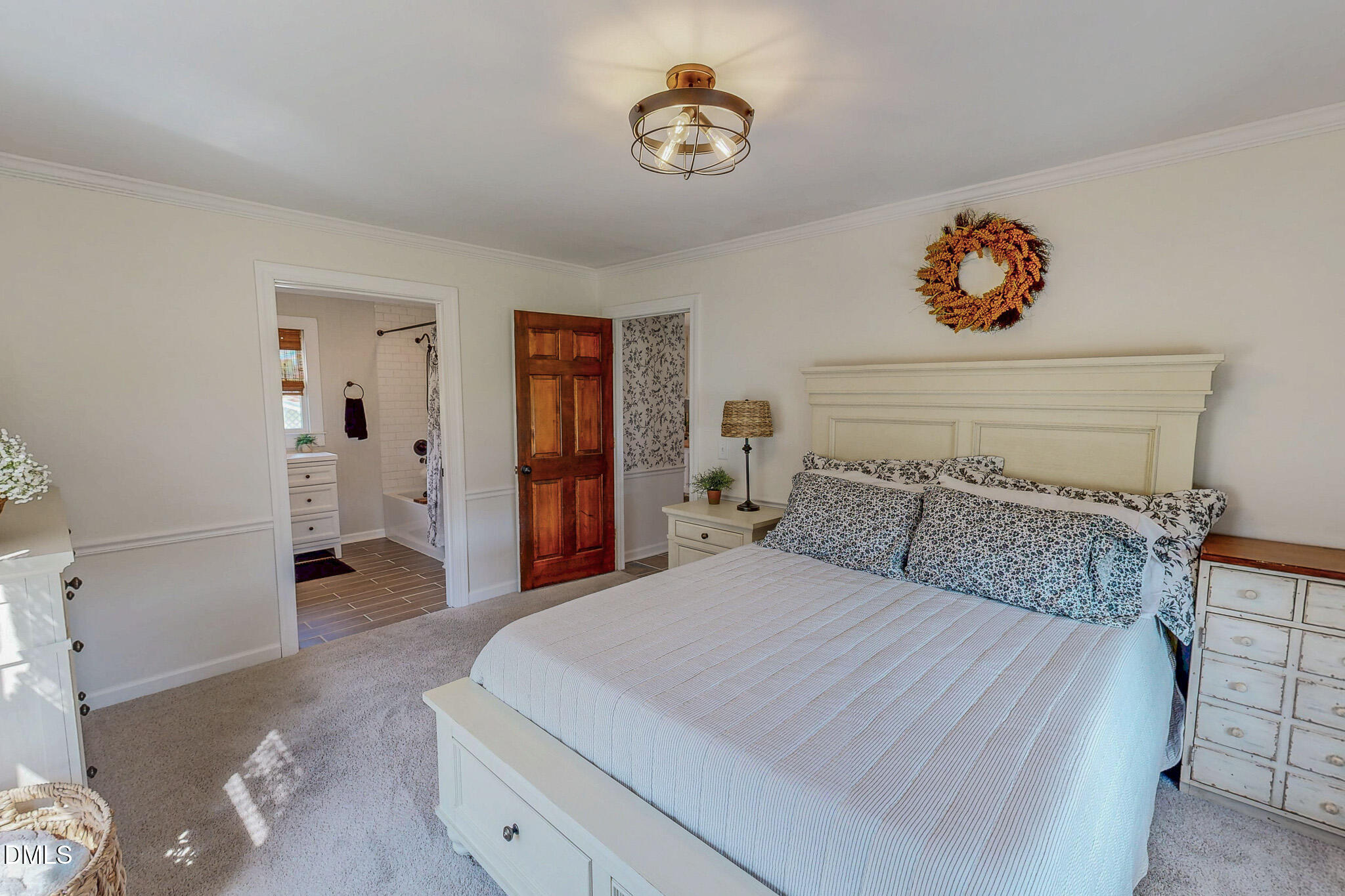 7810 Helena Moriah Road Rougemont, NC 27572 - Photo 16 of 53 a bedroom with a large bed and a chandelier