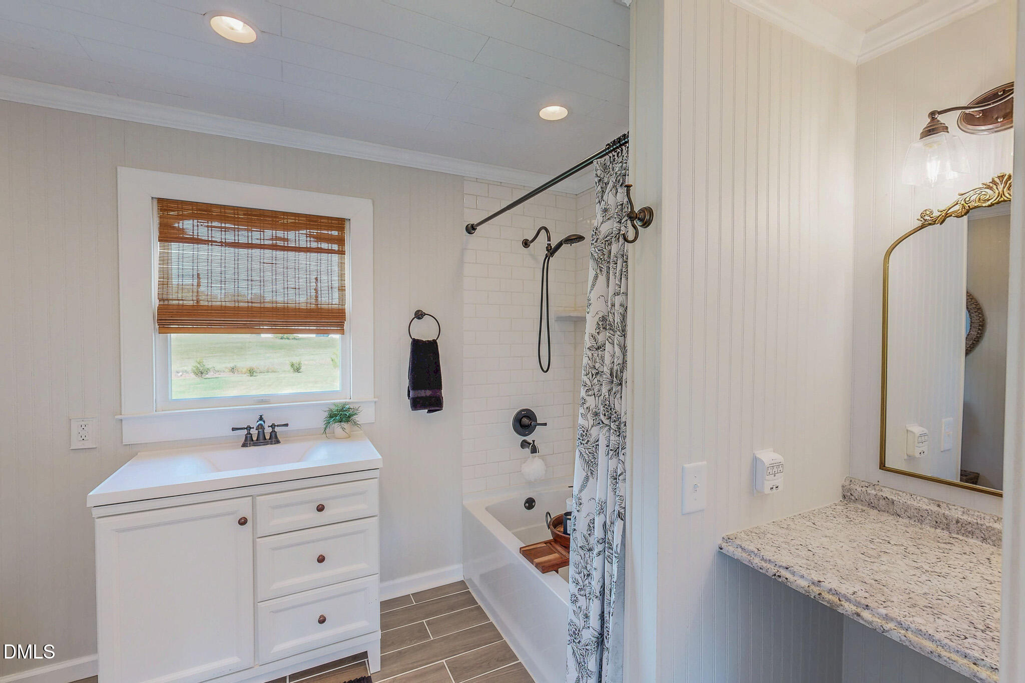 7810 Helena Moriah Road Rougemont, NC 27572 - Photo 19 of 53 a bathroom with a granite countertop sink a mirror a shower and a bathtub