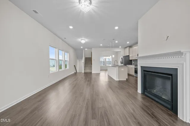 a view of a room with kitchen and fireplace wooden floor
