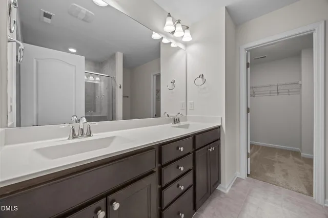 a bathroom with a sink double vanity and a shower