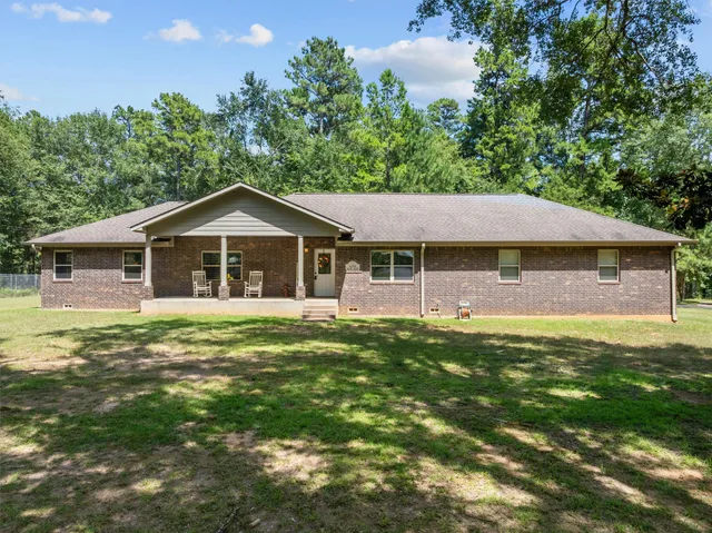 a aerial view of a house with swimming pool having outdoor seating