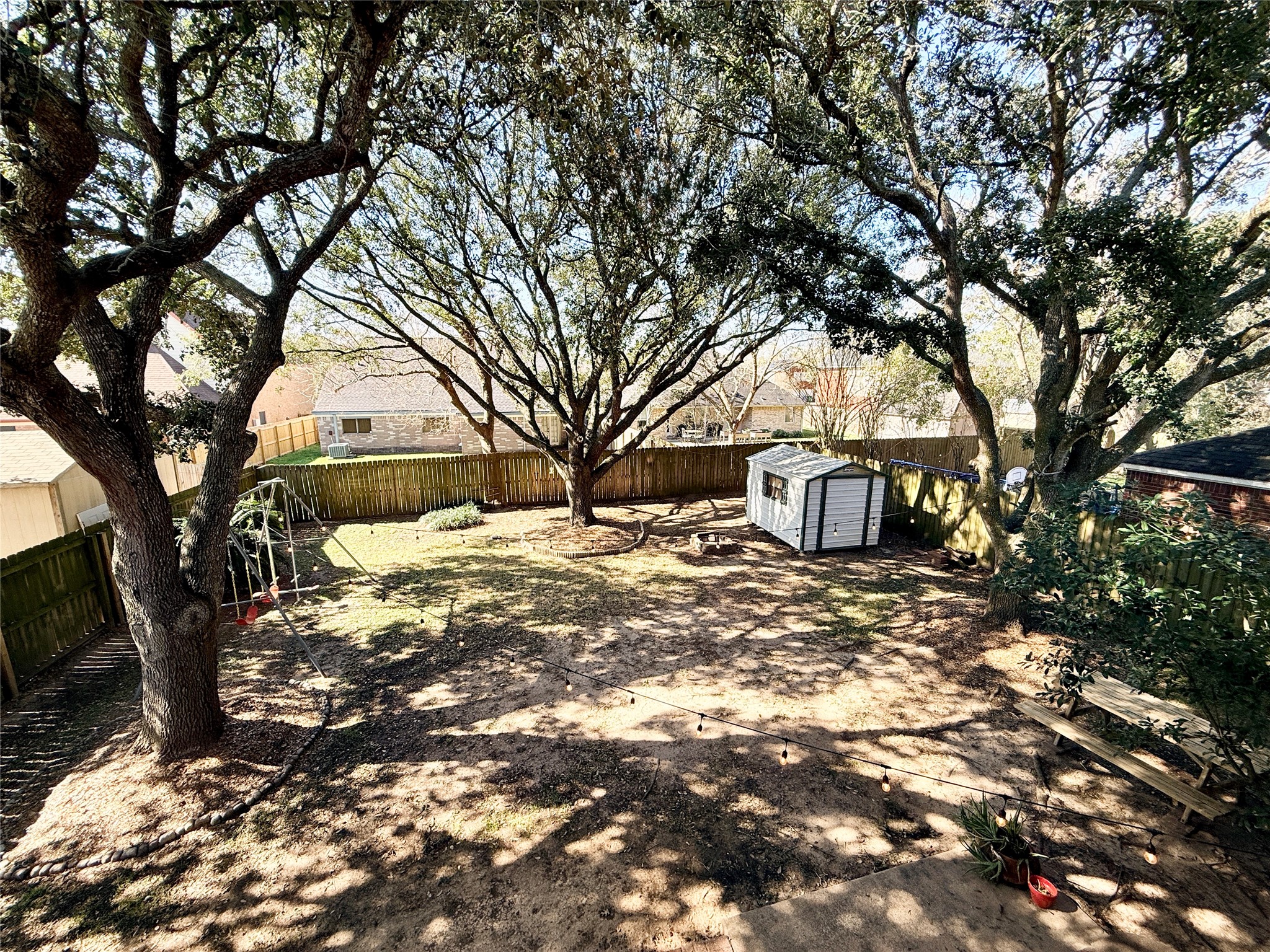 245 North Ranch House Road Angleton, TX 77515 - Photo 15 of 19 This backyard offers a peaceful outdoor retreat with plenty of tree cover and open space perfect for relaxation or entertaining.