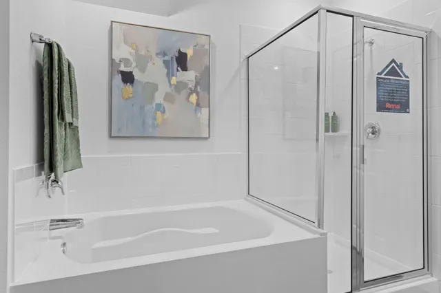 a bathroom with a shower and a tub