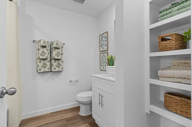 a white toilet sitting next to a bathroom sink